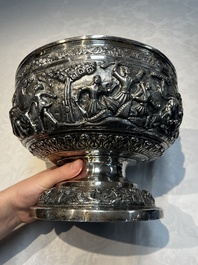 A large repouss&eacute; silver footed bowl depicting a hunting scene, India, late 19/early 20th C.