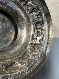 A large repouss&eacute; silver footed bowl depicting a hunting scene, India, late 19/early 20th C.