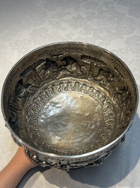 A large repouss&eacute; silver footed bowl depicting a hunting scene, India, late 19/early 20th C.