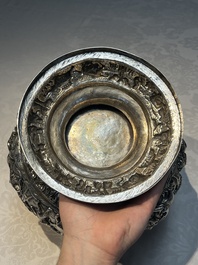 A large repouss&eacute; silver footed bowl depicting a hunting scene, India, late 19/early 20th C.