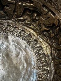A large repouss&eacute; silver footed bowl depicting a hunting scene, India, late 19/early 20th C.