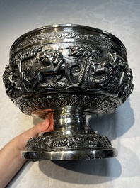 A large repouss&eacute; silver footed bowl depicting a hunting scene, India, late 19/early 20th C.