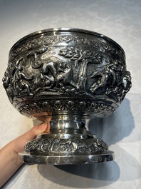 A large repouss&eacute; silver footed bowl depicting a hunting scene, India, late 19/early 20th C.