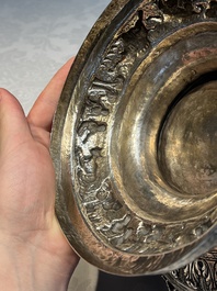 A large repouss&eacute; silver footed bowl depicting a hunting scene, India, late 19/early 20th C.