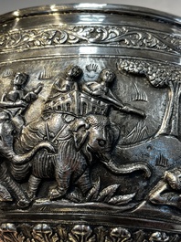 A large repouss&eacute; silver footed bowl depicting a hunting scene, India, late 19/early 20th C.