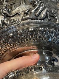 A large repouss&eacute; silver footed bowl depicting a hunting scene, India, late 19/early 20th C.