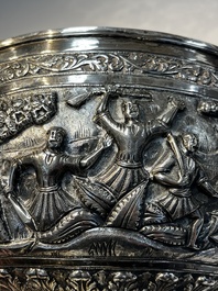 A large repouss&eacute; silver footed bowl depicting a hunting scene, India, late 19/early 20th C.