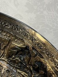 A large repouss&eacute; silver footed bowl depicting a hunting scene, India, late 19/early 20th C.