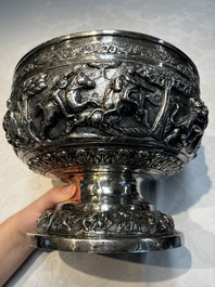 A large repouss&eacute; silver footed bowl depicting a hunting scene, India, late 19/early 20th C.