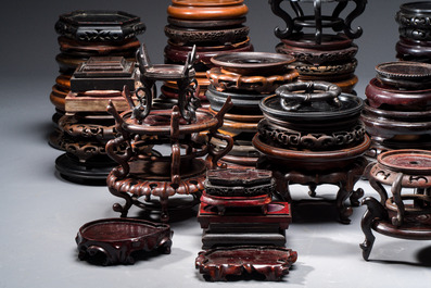 A collection of 70 Chinese wooden stands, 19/20th C.
