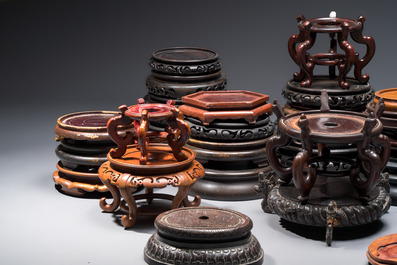A collection of 40 mainly Chinese wooden stands, 19/20th C.