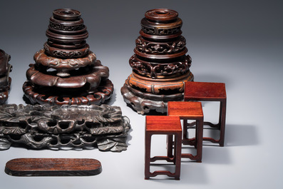 A collection of 25 Chinese wooden stands, 19/20th C.