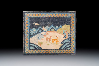 A Chinese woollen 'Cranes and Deer' carpet, 20th C.