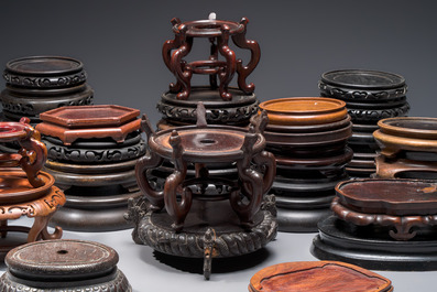 A collection of 40 mainly Chinese wooden stands, 19/20th C.