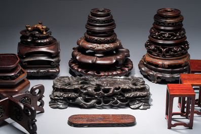 A collection of 25 Chinese wooden stands, 19/20th C.
