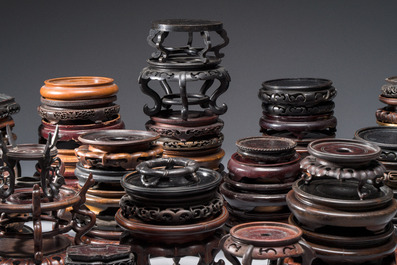 A collection of 70 Chinese wooden stands, 19/20th C.