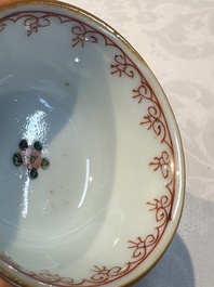 A Chinese famille verte teapot and three famille rose capucine-ground cups and saucers, Kangxi/Qianlong