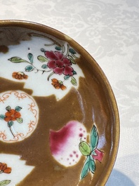 A Chinese famille verte teapot and three famille rose capucine-ground cups and saucers, Kangxi/Qianlong