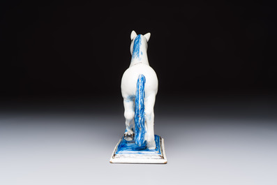A polychrome Dutch Delft model of a standing horse with a figurative saddle cloth, 18th C.
