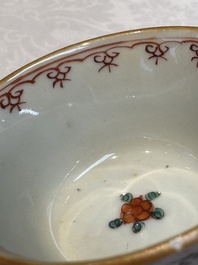 A Chinese famille verte teapot and three famille rose capucine-ground cups and saucers, Kangxi/Qianlong