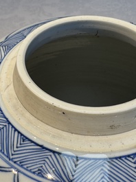 A Chinese blue and white 'Antiquities and Flower Baskets' vase with a wooden cover, Kangxi