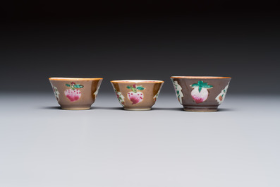 A Chinese famille verte teapot and three famille rose capucine-ground cups and saucers, Kangxi/Qianlong