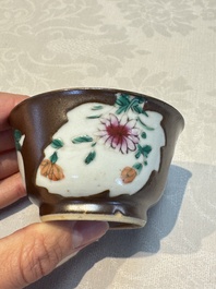 A Chinese famille verte teapot and three famille rose capucine-ground cups and saucers, Kangxi/Qianlong
