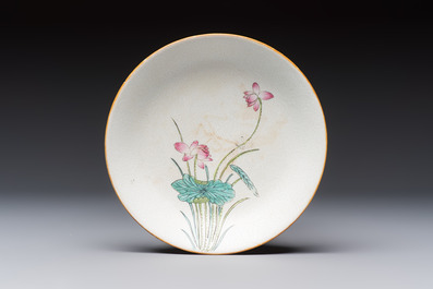 Four Chinese famille rose saucers and a gilt-decorated powder-blue-ground saucer, Qianlong and Jiaqing marks, 18/19th C.