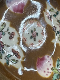 A Chinese famille verte teapot and three famille rose capucine-ground cups and saucers, Kangxi/Qianlong