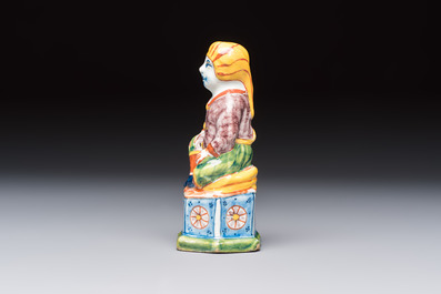 A polychrome Dutch Delft model of a seated oriental figure, 18th C.