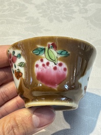 A Chinese famille verte teapot and three famille rose capucine-ground cups and saucers, Kangxi/Qianlong