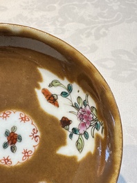 A Chinese famille verte teapot and three famille rose capucine-ground cups and saucers, Kangxi/Qianlong