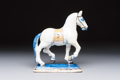 A polychrome Dutch Delft model of a standing horse with a figurative saddle cloth, 18th C.
