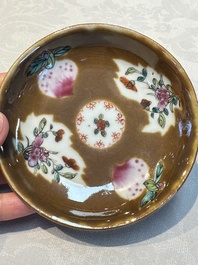 A Chinese famille verte teapot and three famille rose capucine-ground cups and saucers, Kangxi/Qianlong