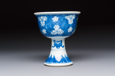 A Chinese blue and white 'Prunus on Cracked Ice' stem bowl, Kangxi
