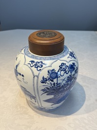 A Chinese blue and white 'Antiquities and Flower Baskets' vase with a wooden cover, Kangxi