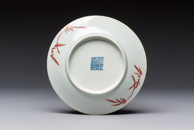 Four Chinese famille rose saucers and a gilt-decorated powder-blue-ground saucer, Qianlong and Jiaqing marks, 18/19th C.