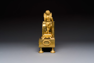 A French fire-gilt mantel clock with a music making cherub, early 19th C.