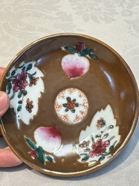 A Chinese famille verte teapot and three famille rose capucine-ground cups and saucers, Kangxi/Qianlong