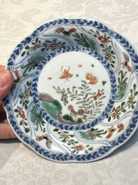 Seven Chinese famille verte cups and four saucers, conch shell and lingzhi marks, Kangxi