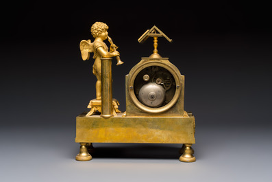 A French fire-gilt mantel clock with a music making cherub, early 19th C.