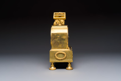 A French fire-gilt mantel clock with a music making cherub, early 19th C.
