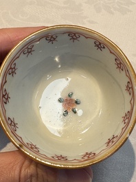 A Chinese famille verte teapot and three famille rose capucine-ground cups and saucers, Kangxi/Qianlong