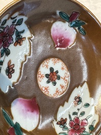 A Chinese famille verte teapot and three famille rose capucine-ground cups and saucers, Kangxi/Qianlong