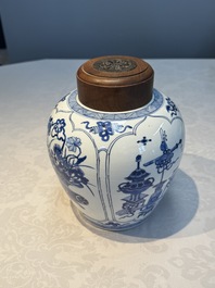 A Chinese blue and white 'Antiquities and Flower Baskets' vase with a wooden cover, Kangxi