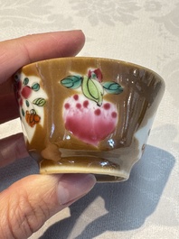 A Chinese famille verte teapot and three famille rose capucine-ground cups and saucers, Kangxi/Qianlong