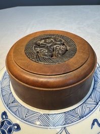 A Chinese blue and white 'Antiquities and Flower Baskets' vase with a wooden cover, Kangxi