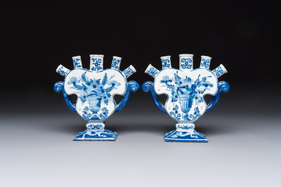 A pair of blue and white Dutch Delft tulip vases with a lady holding a cornucopia, 19th C.