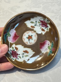 A Chinese famille verte teapot and three famille rose capucine-ground cups and saucers, Kangxi/Qianlong