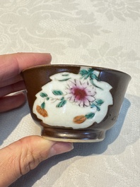 A Chinese famille verte teapot and three famille rose capucine-ground cups and saucers, Kangxi/Qianlong